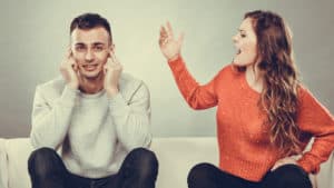Their expression and gesture say that they are annoyed